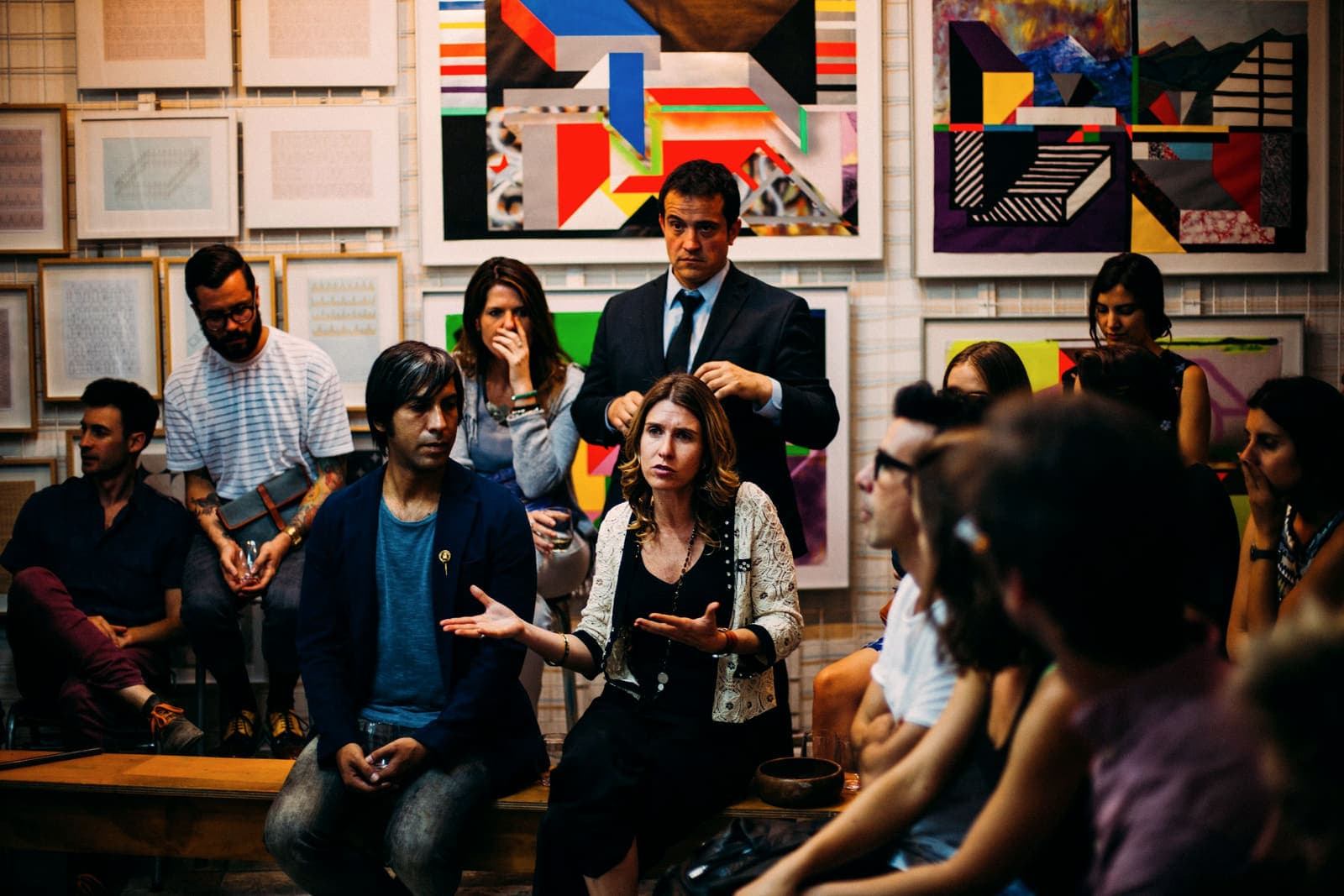 A mixed group in discussion around a table in a bright studio