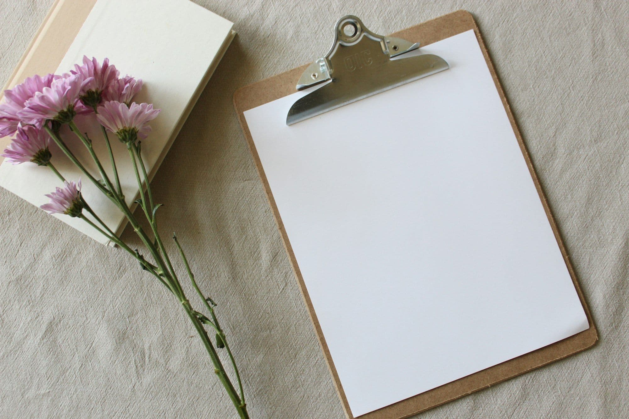 An event planner working through a checklist on a clipboard inside a venue