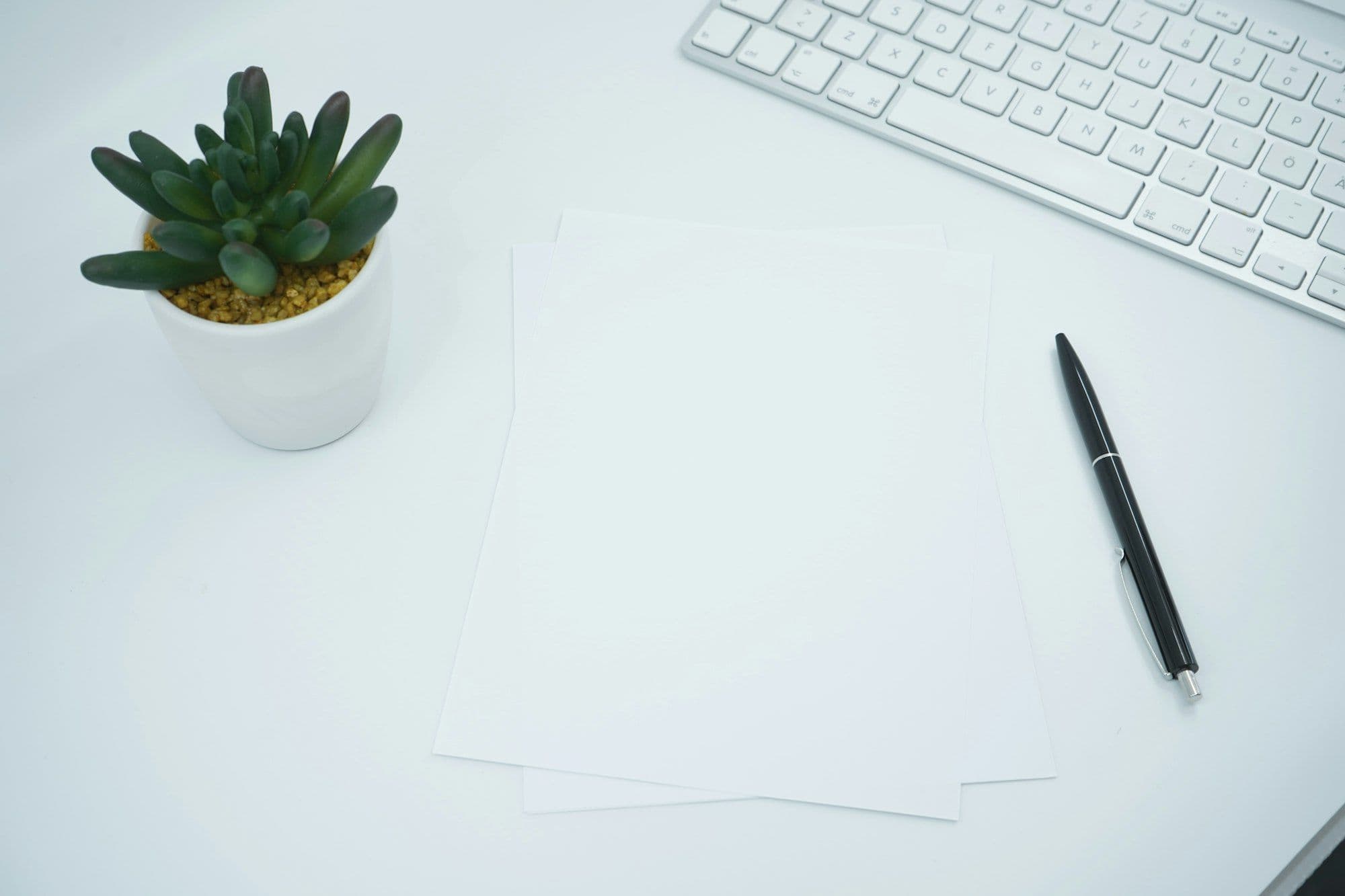 Two people at a desk reviewing and signing a printed contract