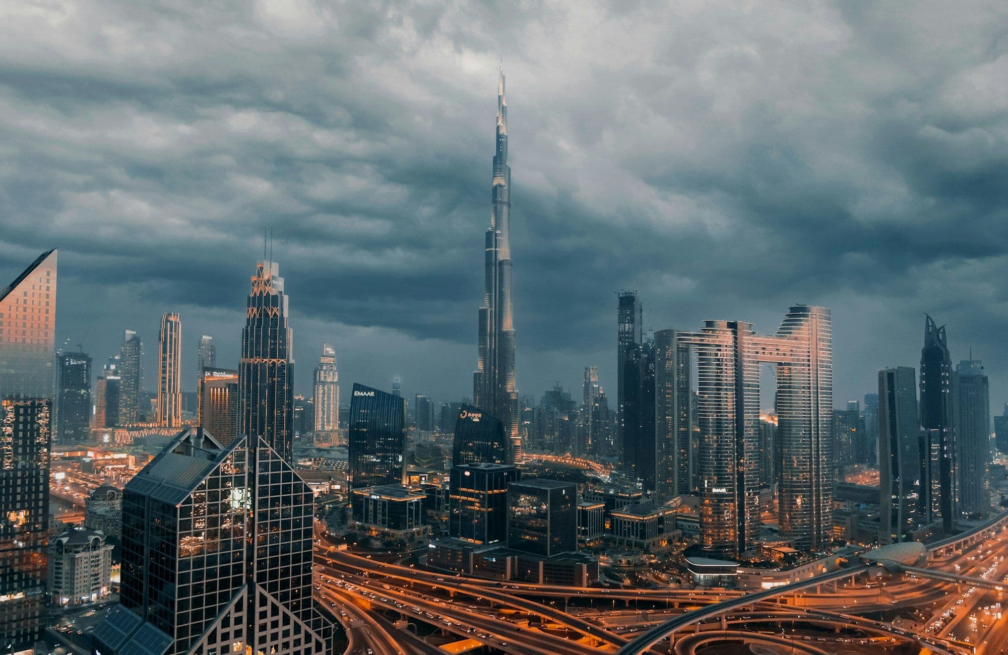 The Dubai skyline at dusk with high-rise towers lit against the sky